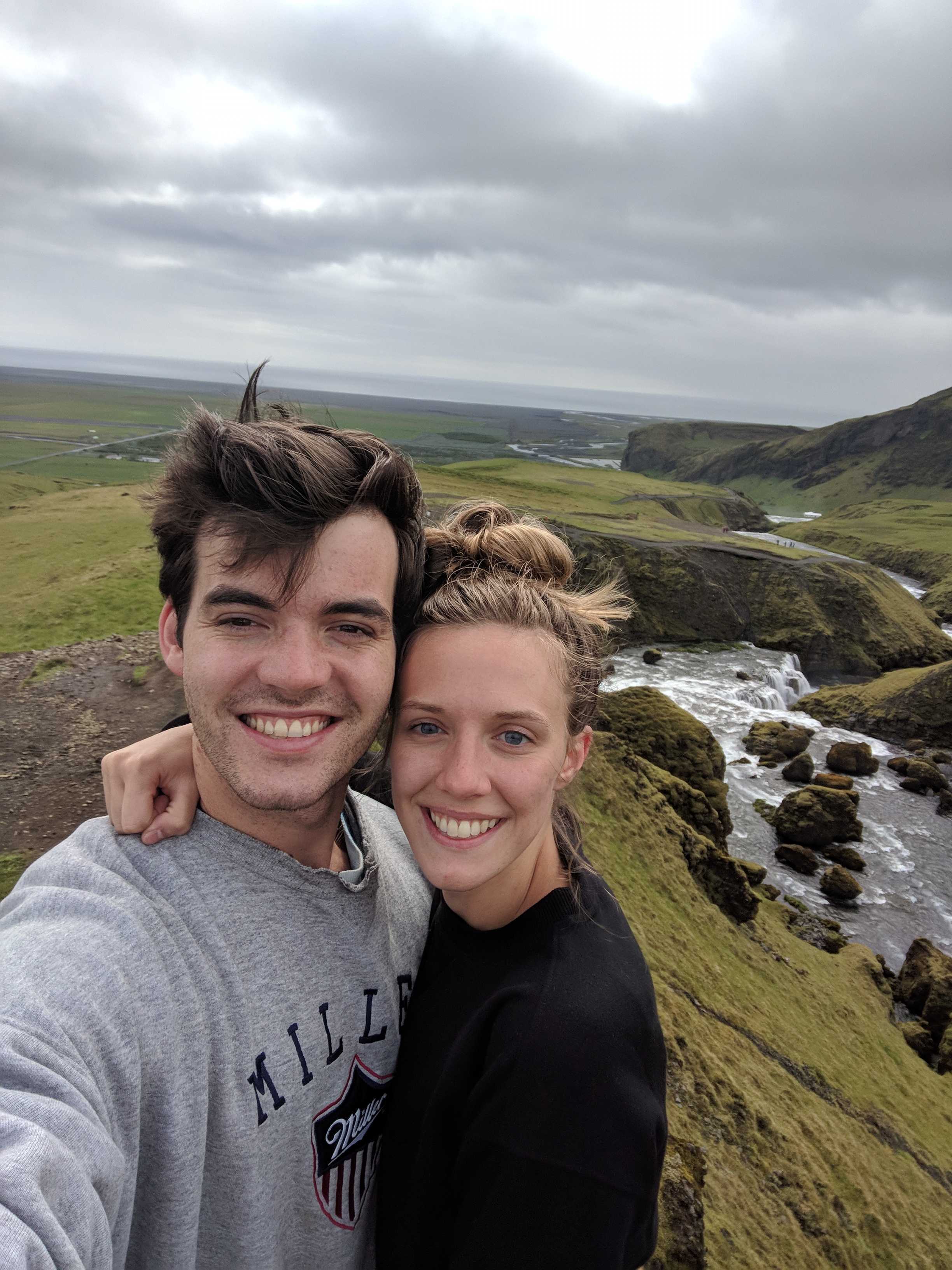 Danny and Bailey smiling together at a waterfall overlook