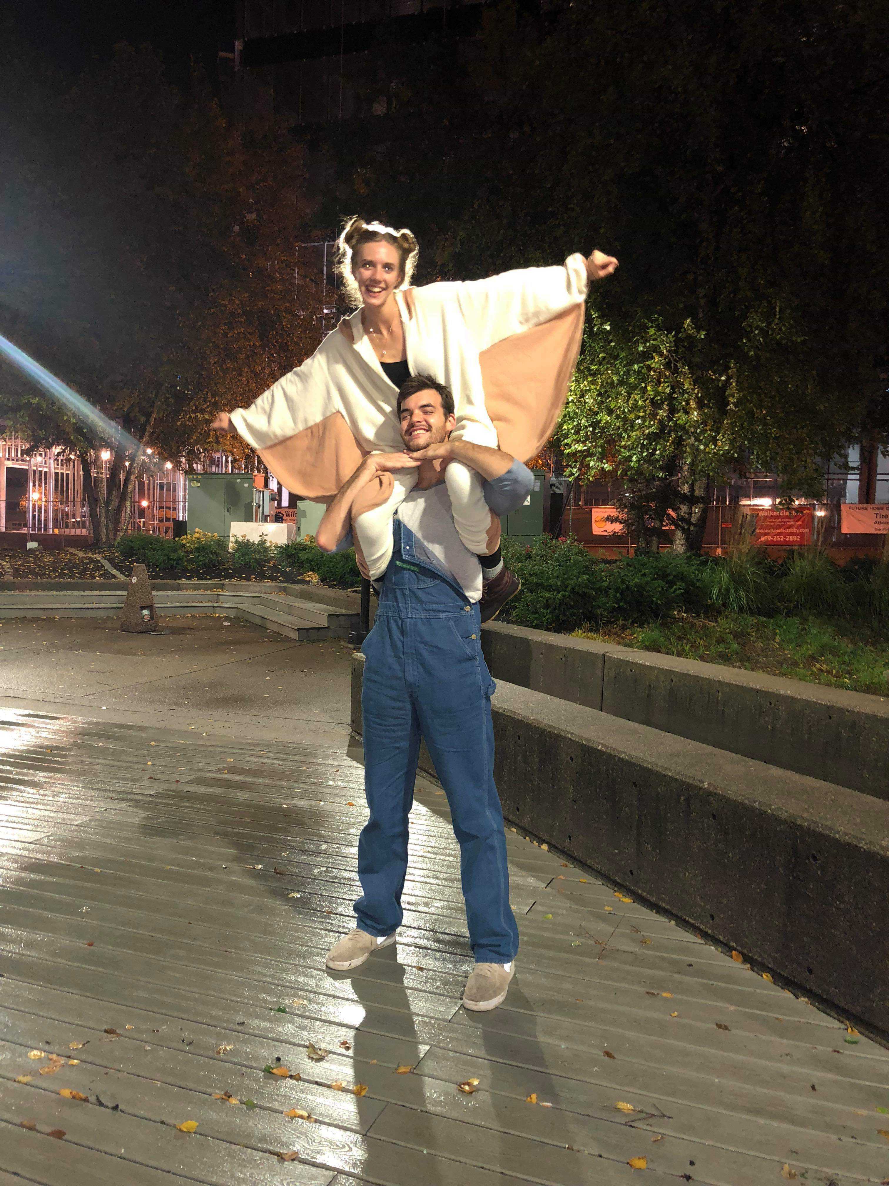 Danny carrying Bailey on his shoulders at night outdoors